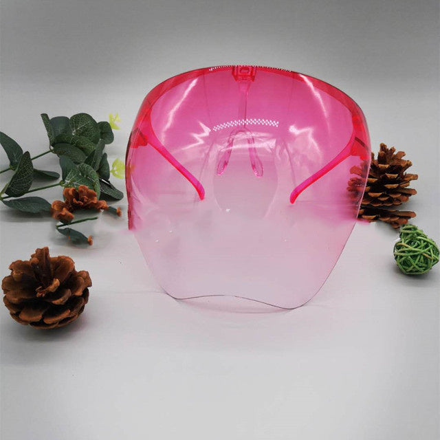 Shopi Vella pink faceshield protective glasses displayed with decorative pinecones and green leaves