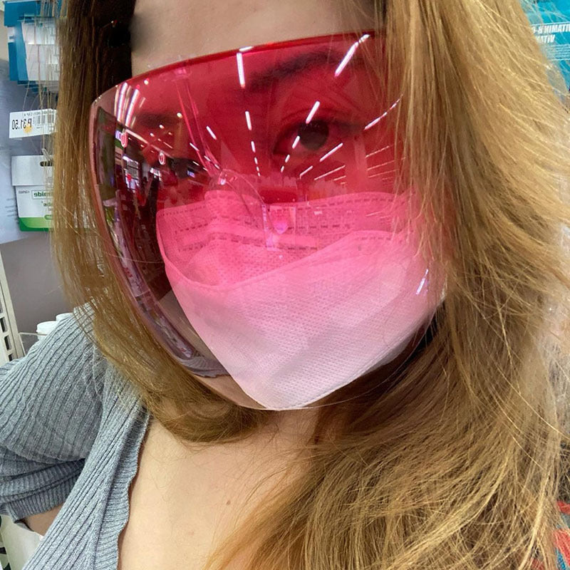 Shopi Vella faceshield protective glasses in red worn over a pink face mask for full face coverage