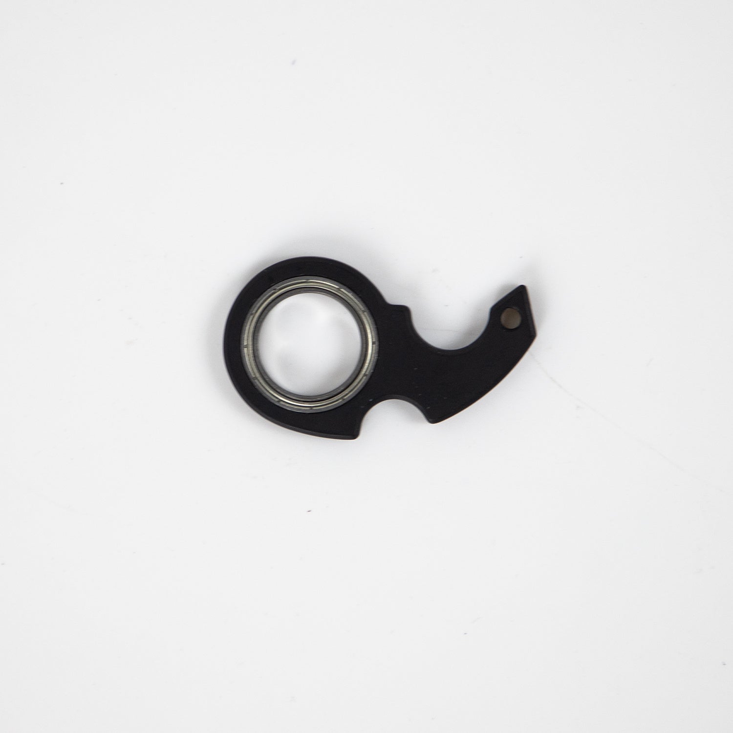 Shopi Vella black finger spinner bottle opener with metal bearing on white background