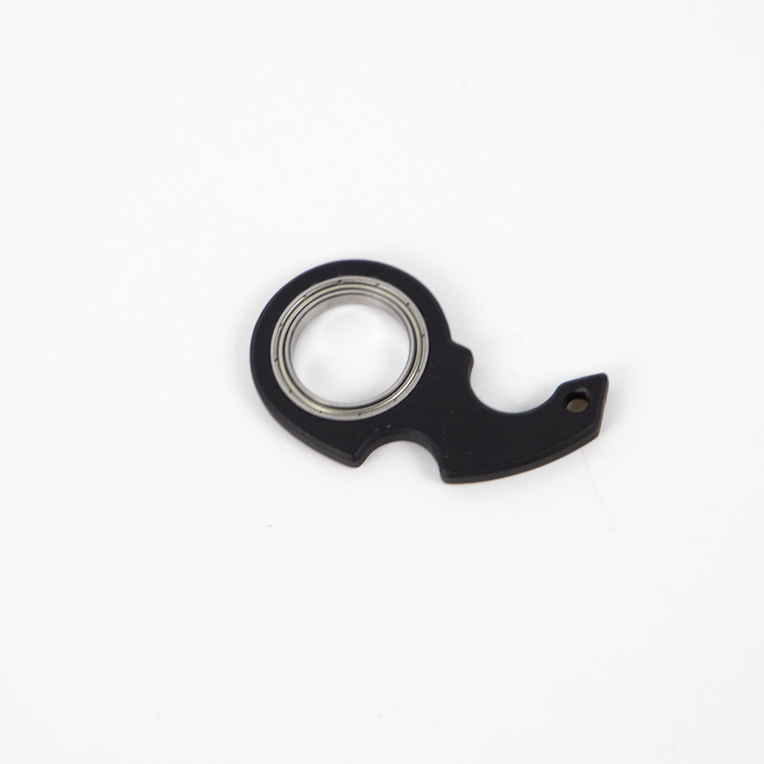 Black finger spinner bottle opener with metal bearing and compact design by Shopi Vella
