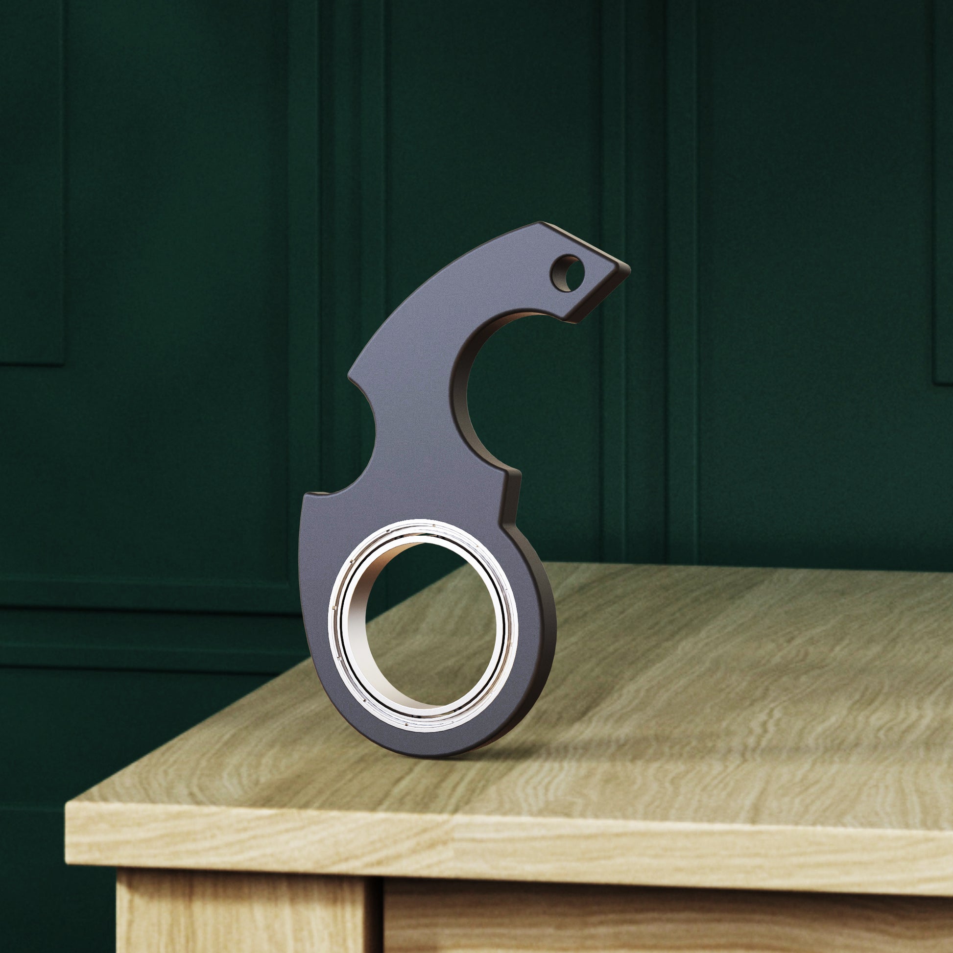 Shopi Vella black metal finger spinner bottle opener placed on wooden table with dark green wall background