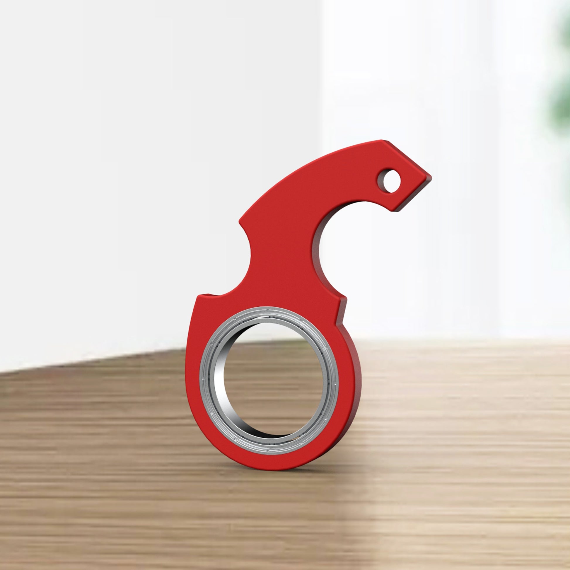 Shopi Vella red finger spinner bottle opener with metal bearing on wooden surface