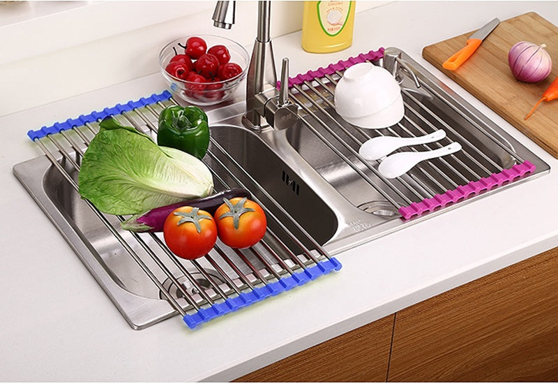 Shopi Vella foldable kitchen sink rack with colorful edges holding vegetables and utensils over double sink