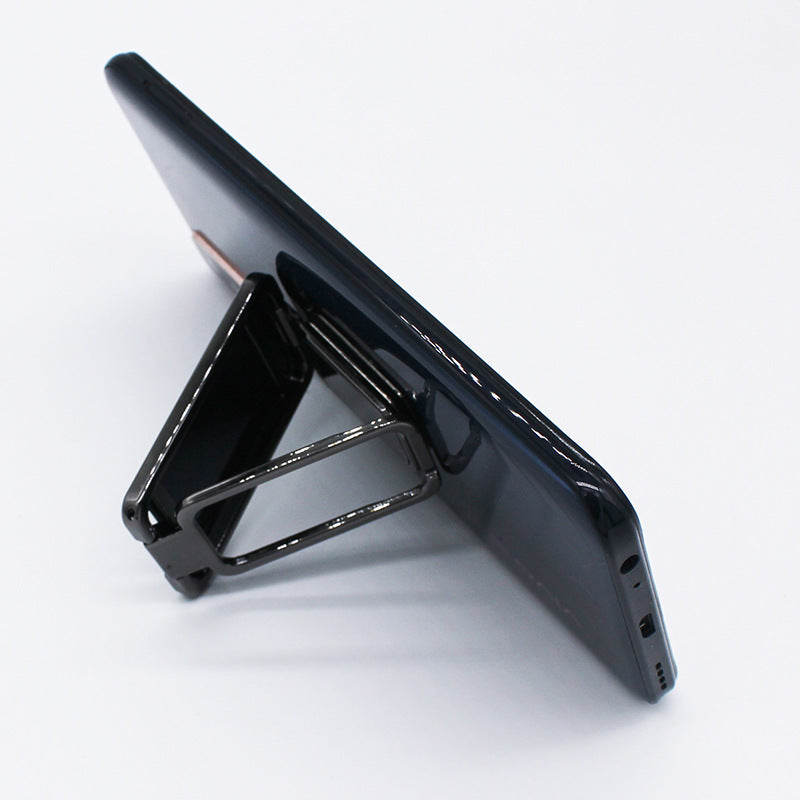 Shopi Vella foldable phone holder stand supporting a black smartphone in landscape mode
