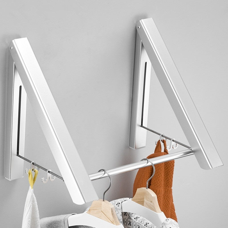 Wall-mounted foldable retractable clothes rack with hanging clothes on metal rod in bathroom