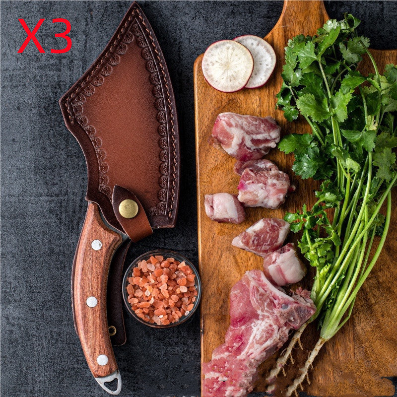 Shopi Vella forged small kitchen knife with wooden handle and leather sheath next to fresh herbs and meat on cutting board