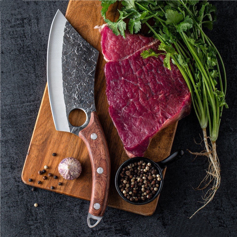 Shopi Vella forged small kitchen knife with wooden handle on cutting board with raw steak and herbs