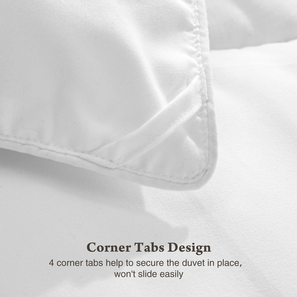 Close-up of white four season down comforter corner tab design by Shopi Vella for secure duvet placement