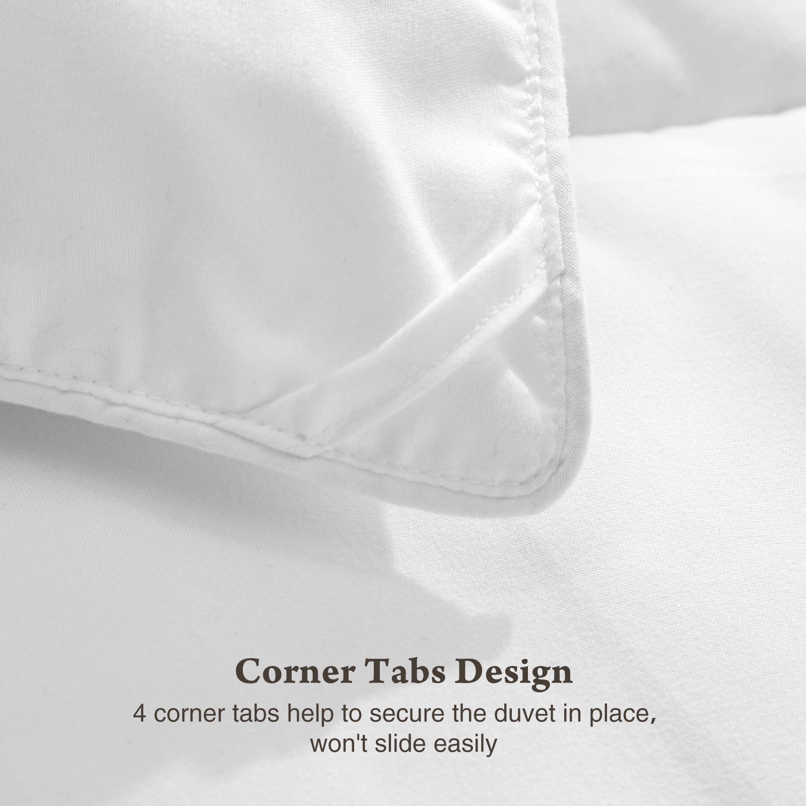 Close-up of white four season down comforter corner tab design by Shopi Vella for secure duvet placement