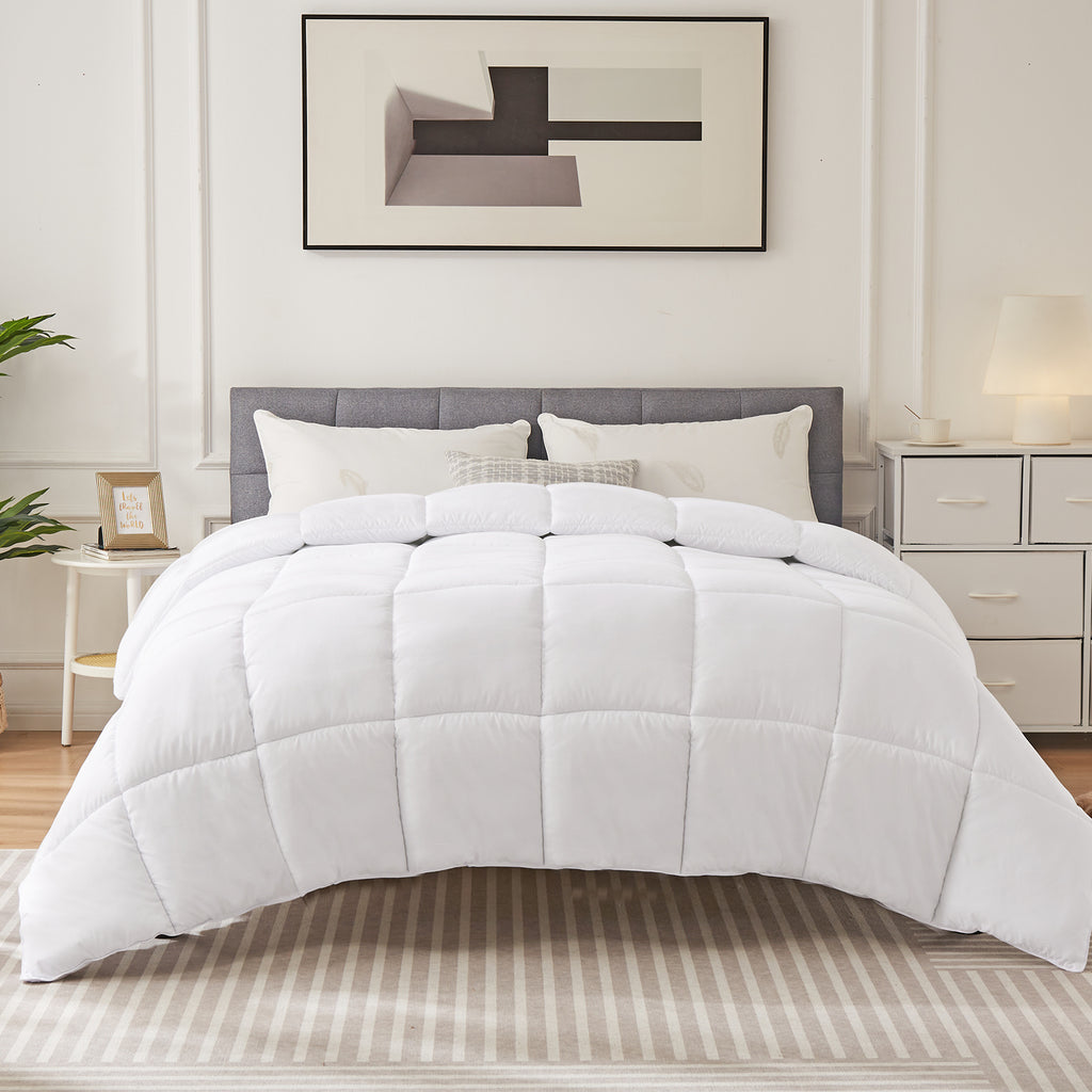 Shopi Vella four season down comforter on bed in modern bedroom with white pillows and abstract wall art