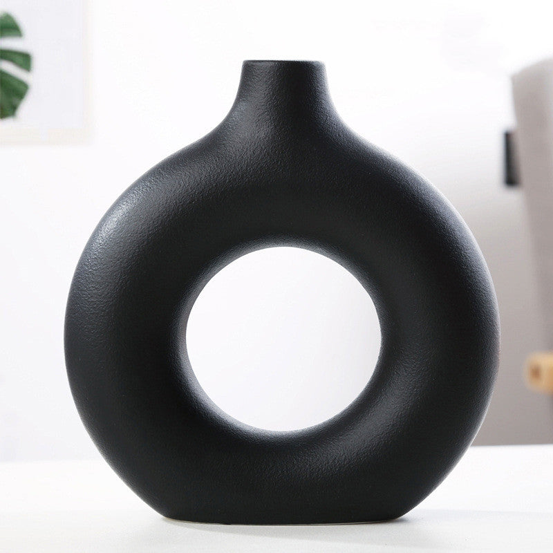 Black frosted particle flower arranging vase with circular hollow design for modern home storage