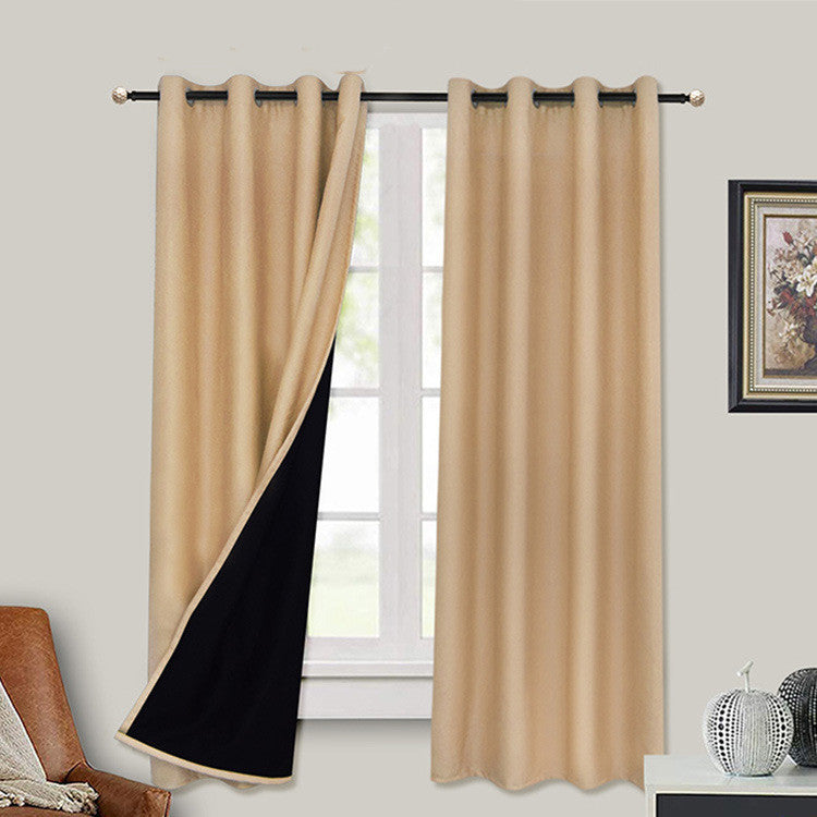 Beige full blackout curtains with liner hanging on window rod in living room setting