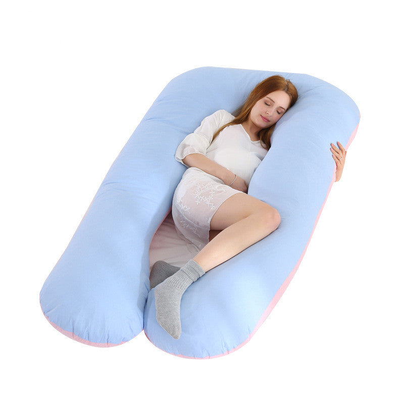 Shopi Vella full body maternity pillow with blue pillow case supporting a pregnant woman sleeping