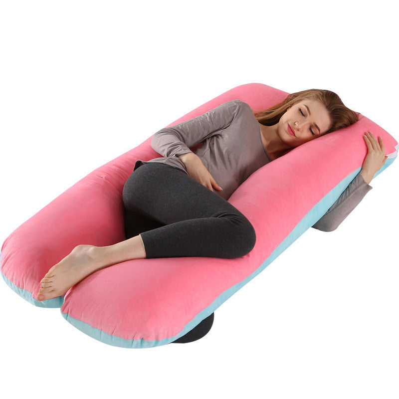 Shopi Vella full body maternity pillow with pink and blue cover supporting a woman lying down comfortably