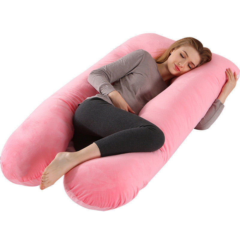 Woman sleeping comfortably on a pink full body maternity pillow with soft pillow case by Shopi Vella