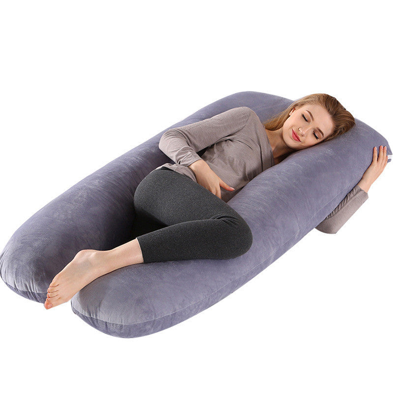 Woman resting comfortably on a gray full body maternity pillow with soft pillow case