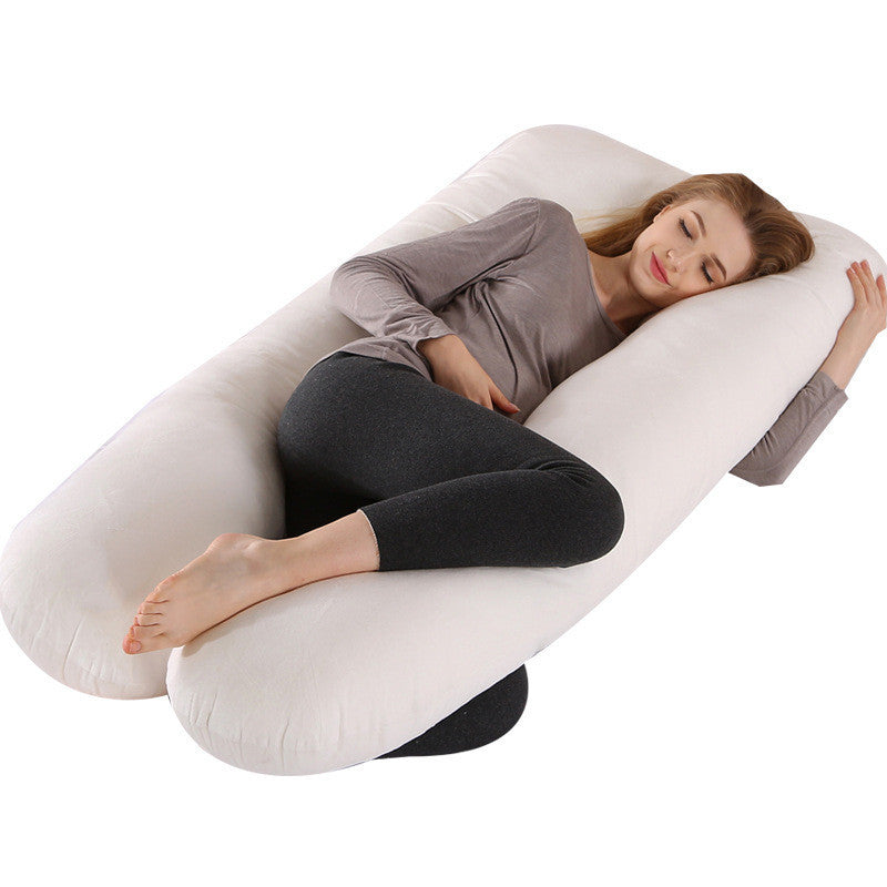 Woman resting comfortably using Shopi Vella full body maternity pillow with white pillow case