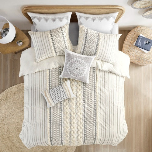 Full queen duvet cover with chenille in neutral tones on a wooden bed with matching pillows