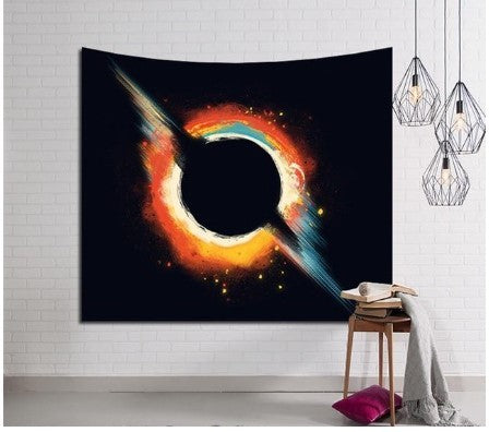 Galaxy wall tapestry by Shopi Vella featuring a vibrant cosmic black hole design hanging on a white brick wall