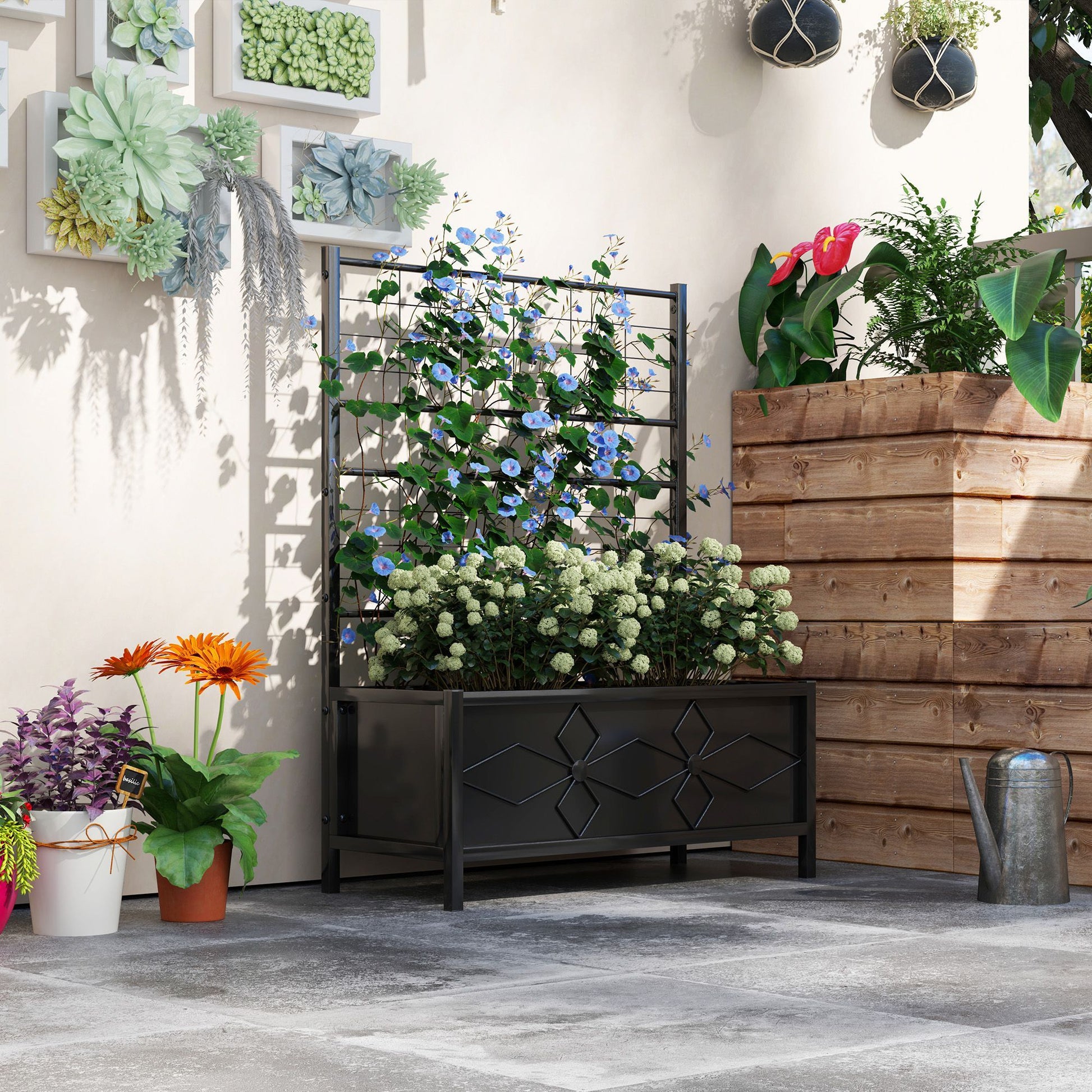 Shopi Vella galvanized raised garden bed with flowering plants in a decorative black storage planter