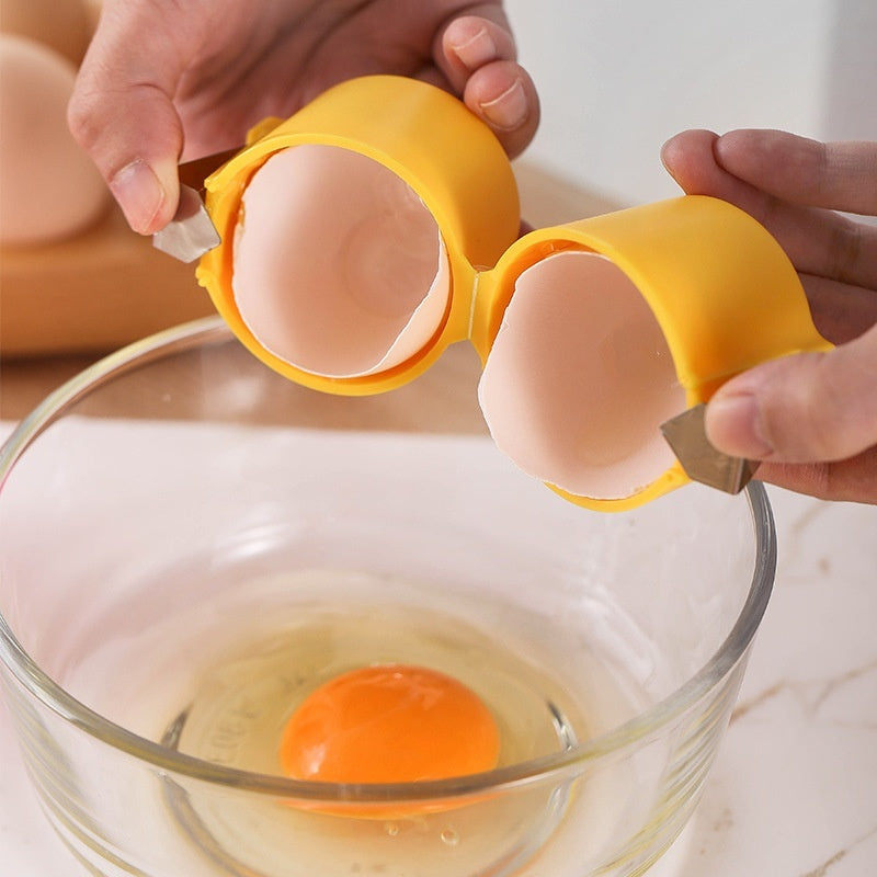 Yellow egg shell opener tool cracking eggshell into glass bowl with fresh egg inside