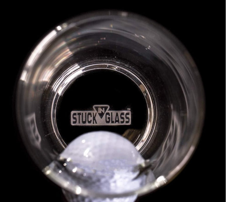 Top view of a golf beer mug with a golf ball stuck inside the glass by Shopi Vella