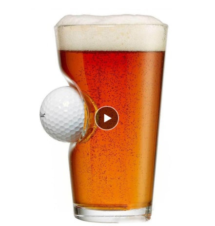 Shopi Vella golf beer mug with a built-in golf ball holder filled with amber beer foam
