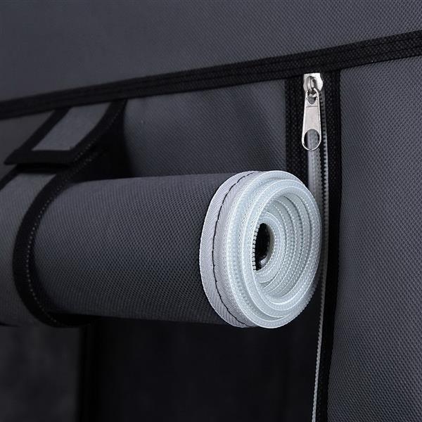 Close-up of gray wardrobe with hanging rod featuring a rolled white storage accessory and zipper detail