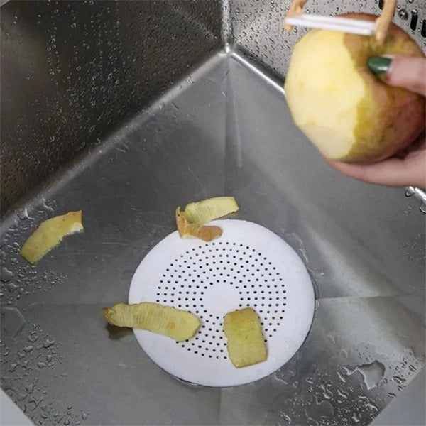 Shopi Vella kitchen sink hair filter placed in stainless steel sink catching fruit peels and debris