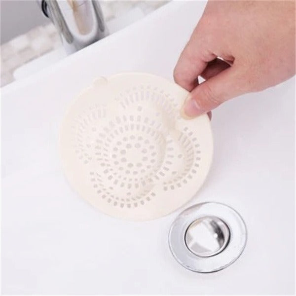 Shopi Vella kitchen sink hair filter being installed in white sink drain for hair and debris trapping