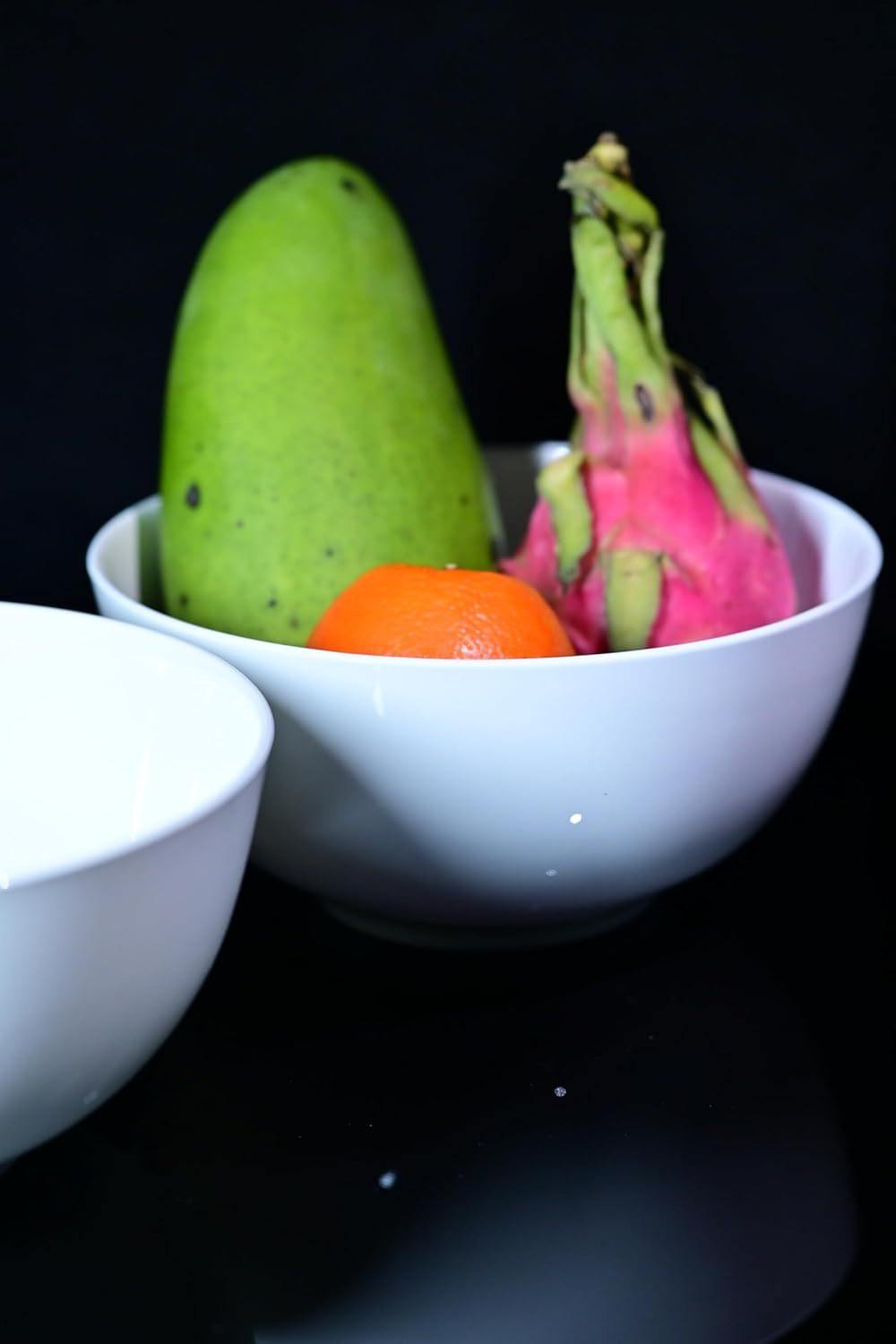 Shopi Vella large deep cereal bowl set in white holding mango, dragon fruit, and orange