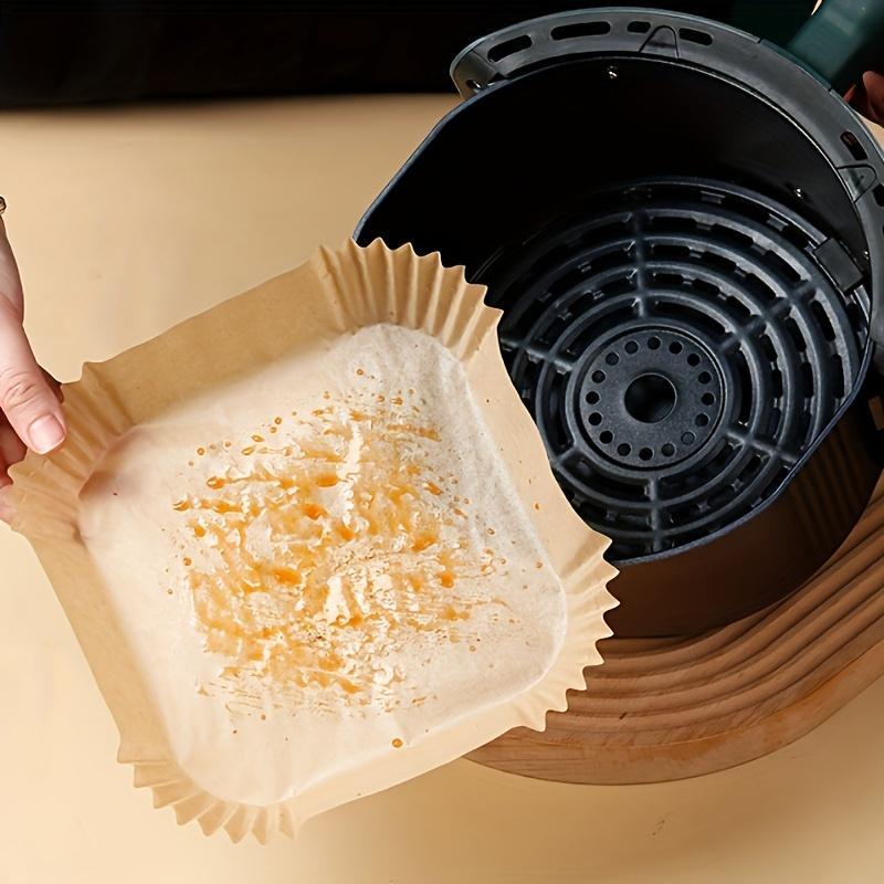 Shopi Vella non-stick air fryer paper 100 pack used in black air fryer basket for easy cleanup