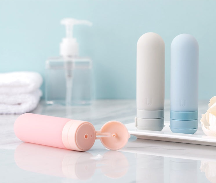 Shopi Vella silicone travel bottles in pastel pink, white, and blue for convenient liquid storage