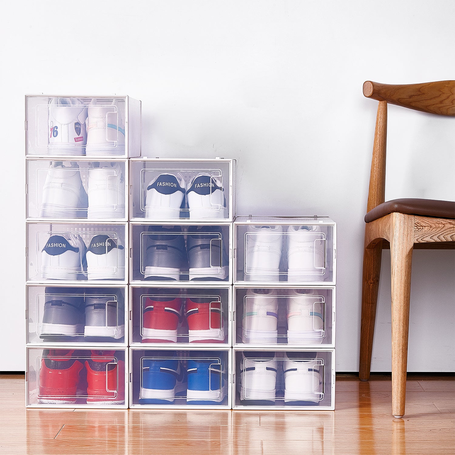 Shopi Vella stackable shoe storage boxes neatly arranged with various sneakers inside near a wooden chair