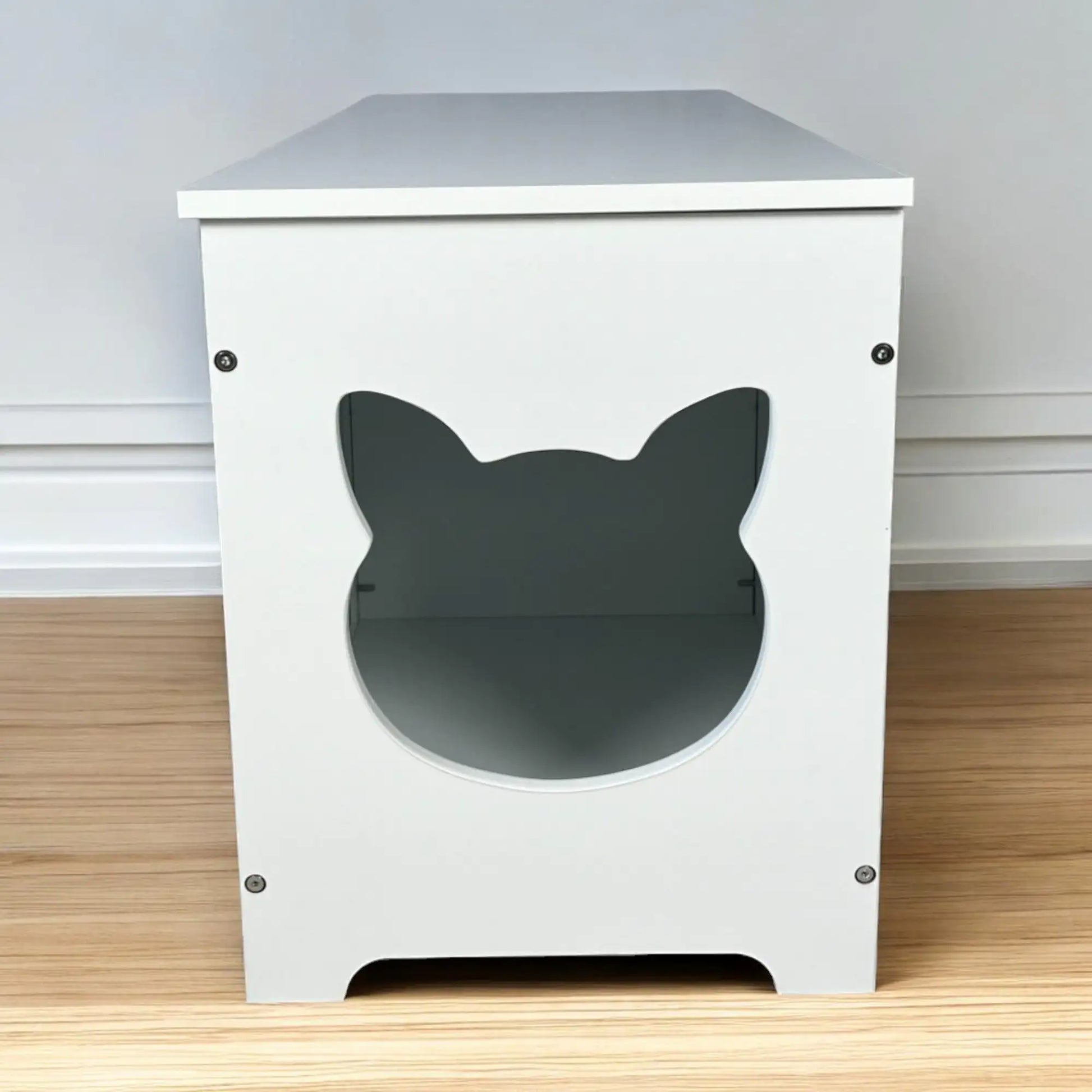 White wooden top open litter box furniture with cat head shaped entrance on hardwood floor
