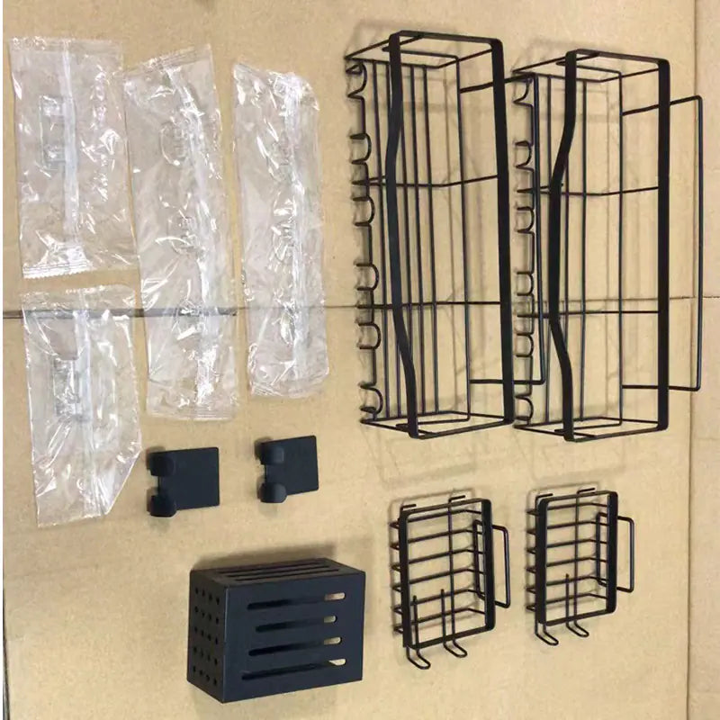 Black metal wall-mounted shower storage rack set with multiple baskets and hooks for organizing bathroom essentials