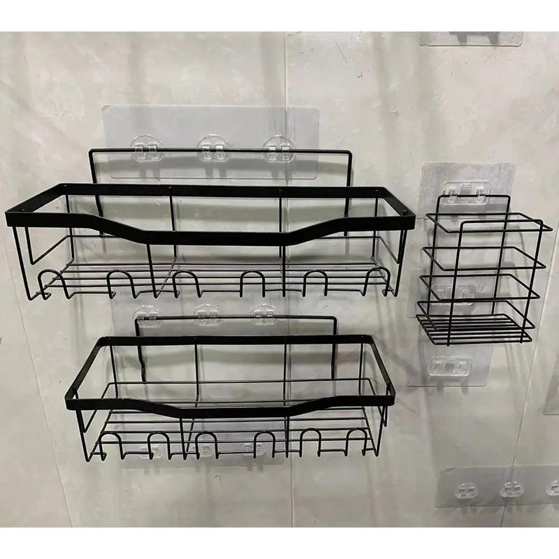 Black metal wall-mounted shower storage rack with hooks and shelves on clear adhesive mounts