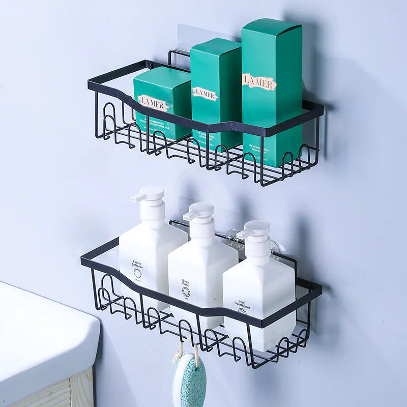 Black metal wall-mounted shower storage rack with multiple sections holding bottles and boxes in bathroom