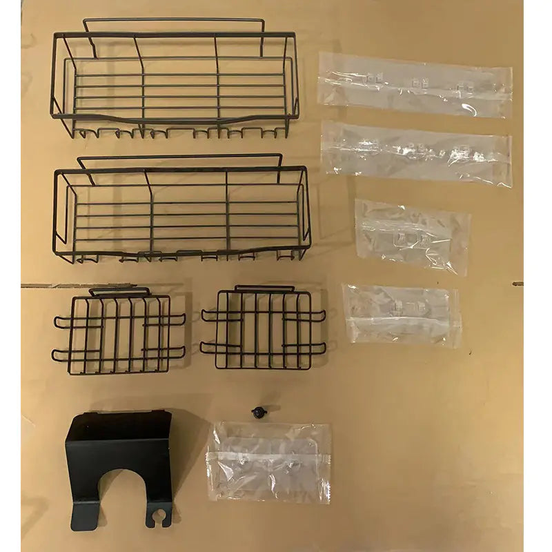 Unassembled black metal wall-mounted shower storage rack with multiple baskets and mounting accessories