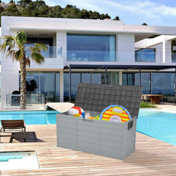 Shopi Vella waterproof patio storage container on wooden deck by pool holding beach toys