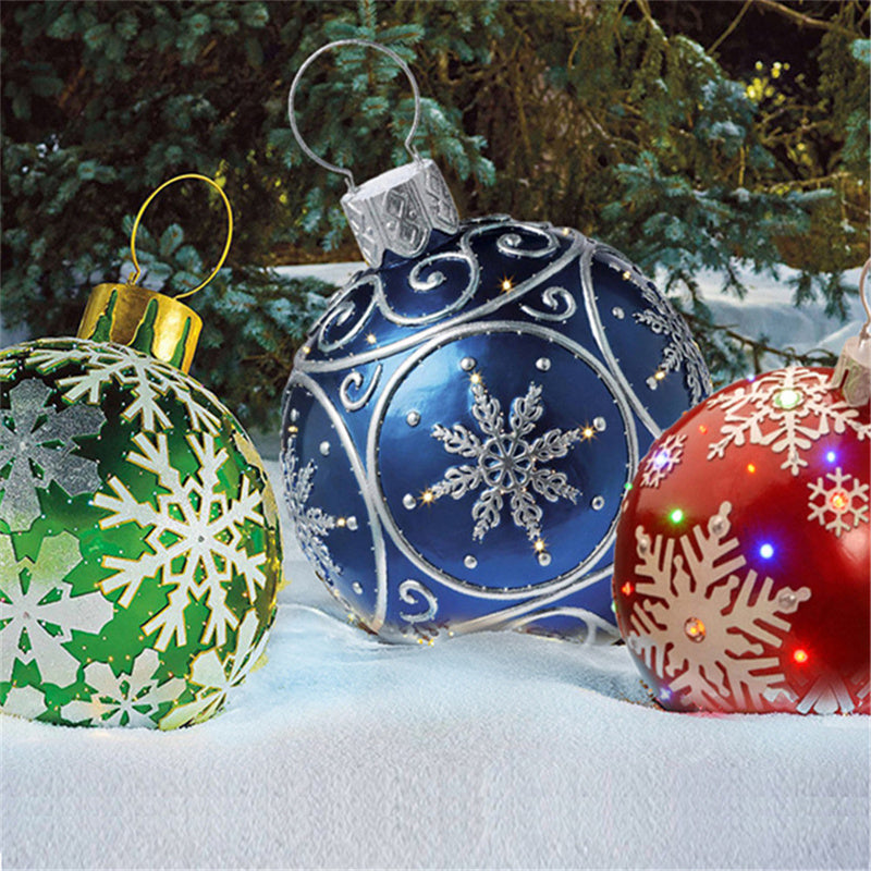 Shopi Vella giant outdoor Christmas ornament ball set with blue, red, and green snowflake designs on snow