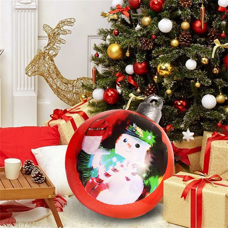 Shopi Vella giant outdoor Christmas ornament ball with snowman design near decorated Christmas tree and wrapped gifts