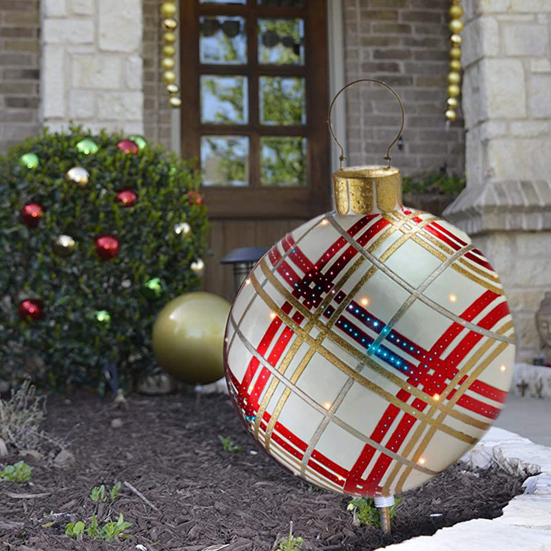 Shopi Vella giant outdoor Christmas ornament ball with red and gold plaid design on front yard