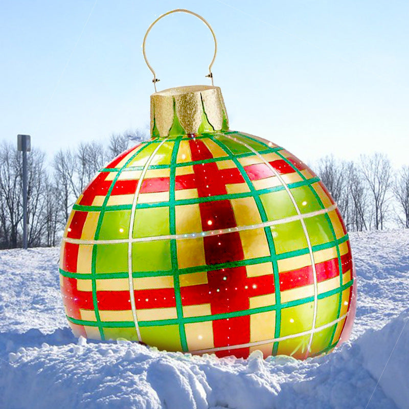 Shopi Vella giant outdoor Christmas ornament ball with red and green plaid pattern on snow