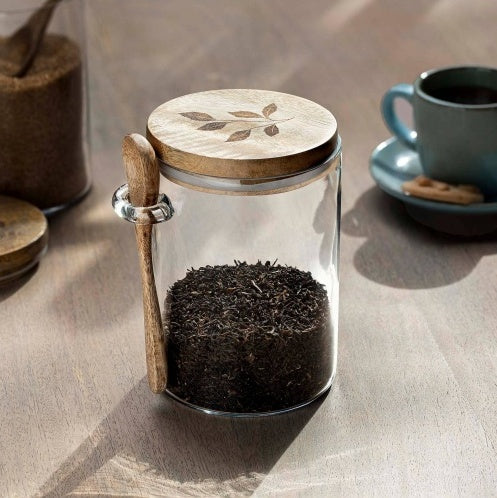Shopi Vella glass kitchen storage jar with wooden lid and spoon holding loose tea leaves