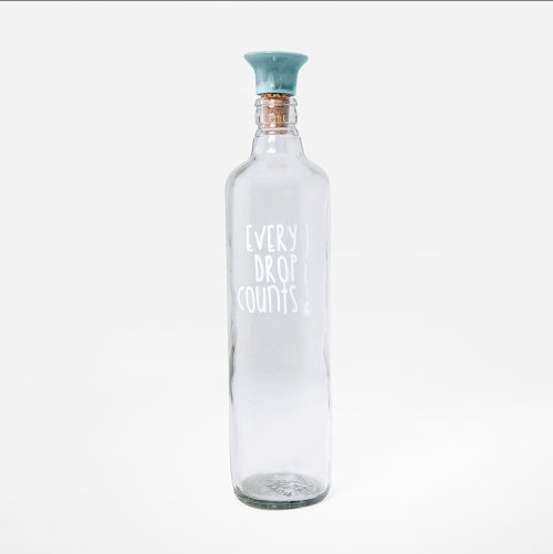 Shopi Vella glass water bottle with ceramic stopper and Every Drop Counts print for storage