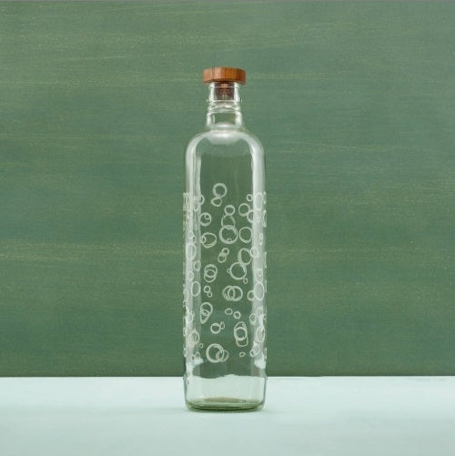 Shopi Vella glass water bottle with wooden stopper featuring clear glass and white bubble design