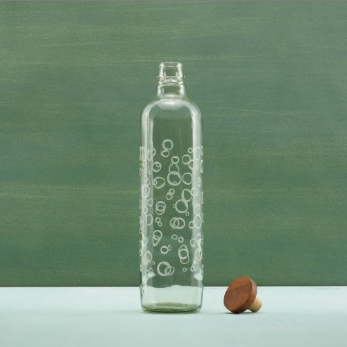 Clear glass water bottle with wooden stopper and circular bubble design by Shopi Vella
