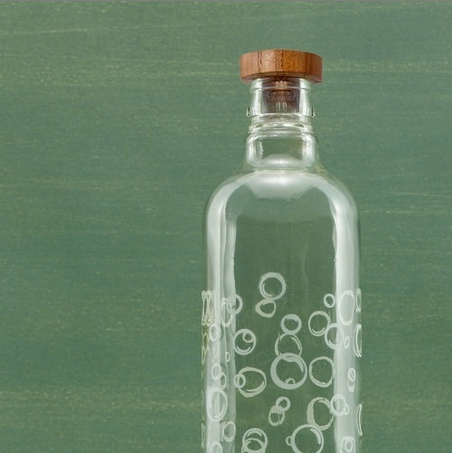 Shopi Vella glass water bottle with wooden stopper and decorative bubble patterns on clear glass