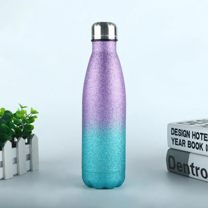 Durable metal sports bottle for hydration with purple to blue gradient glitter finish and silver cap